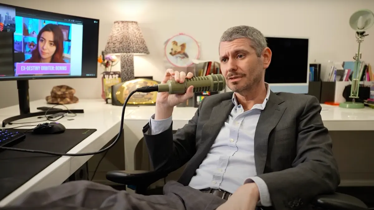 Man podcasting with microphone in modern office setup.