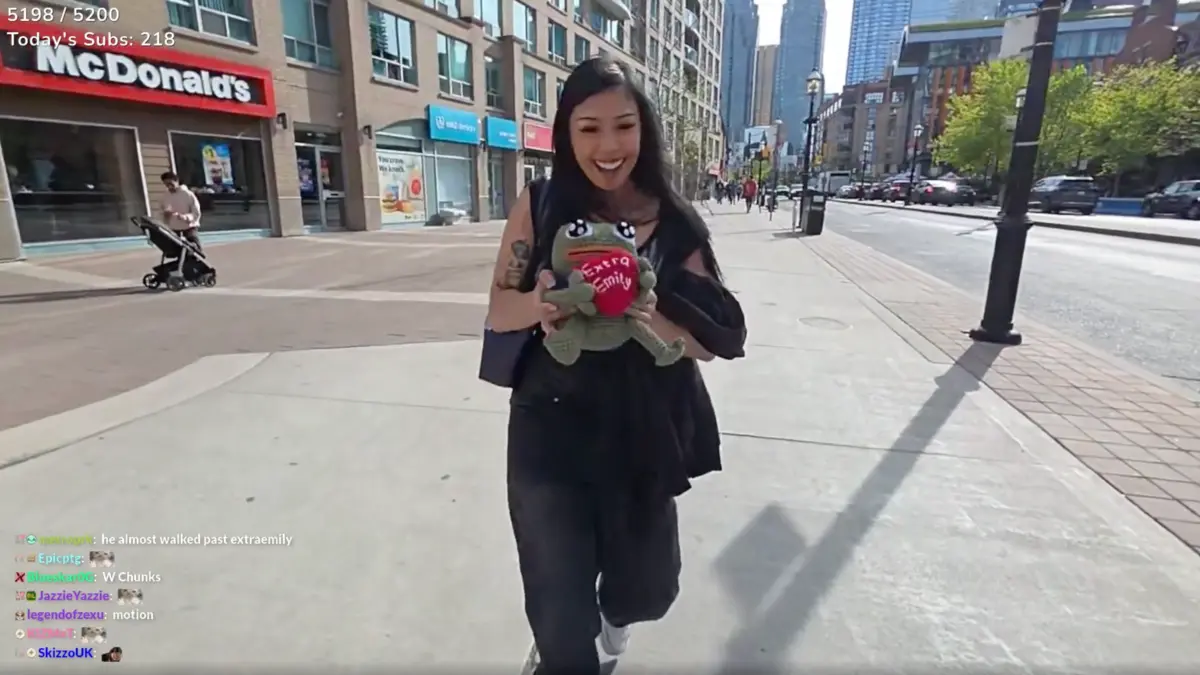 Woman holding plush toy on city sidewalk