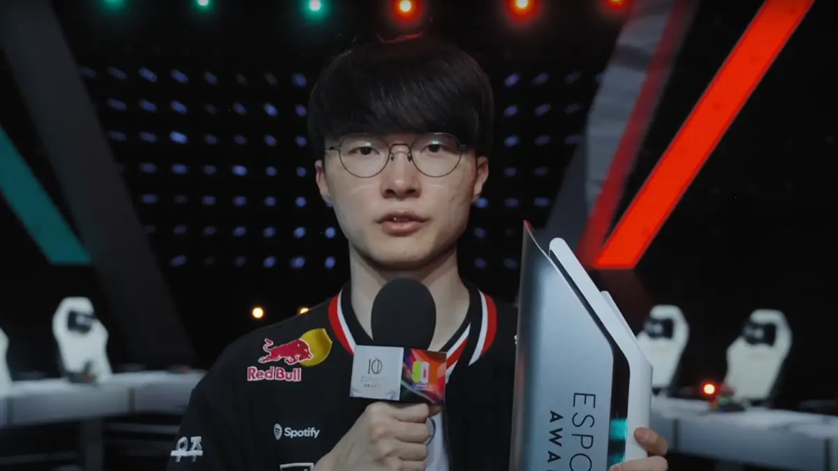 Gamer holding esports trophy and microphone on stage.