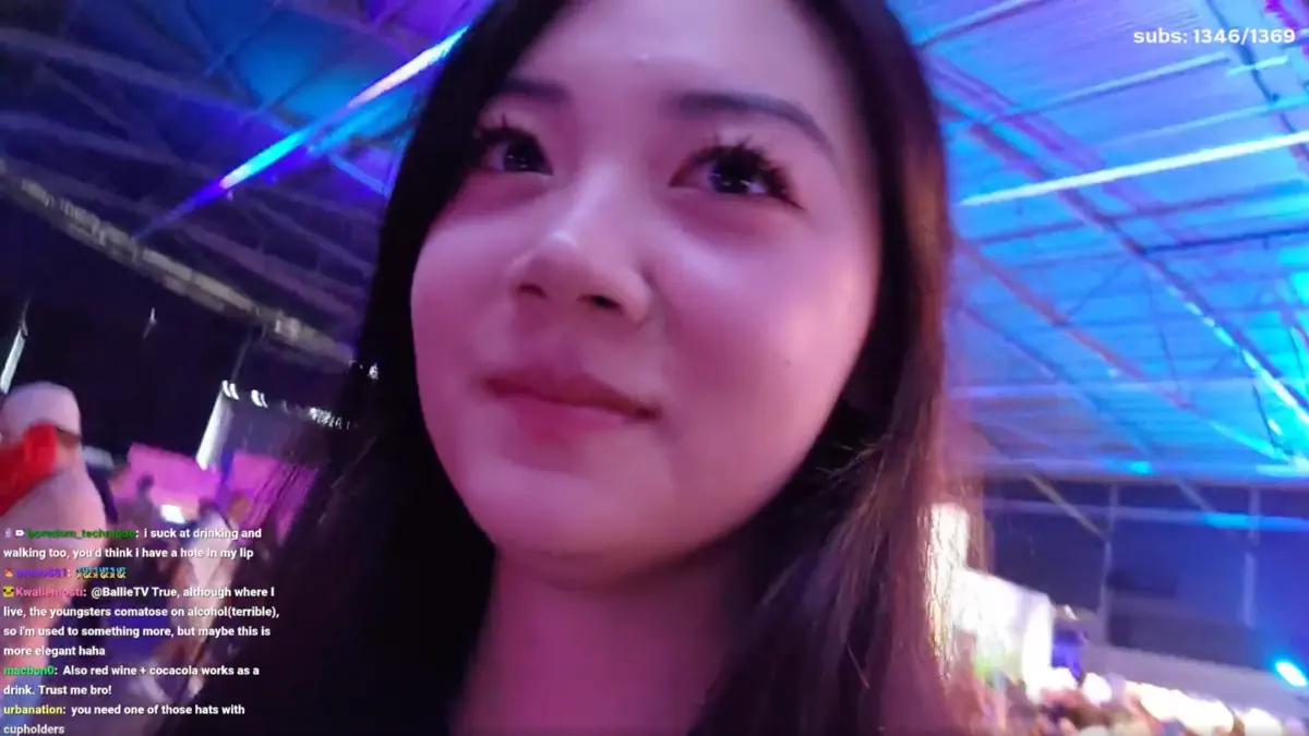 Close-up of woman under colorful neon lights