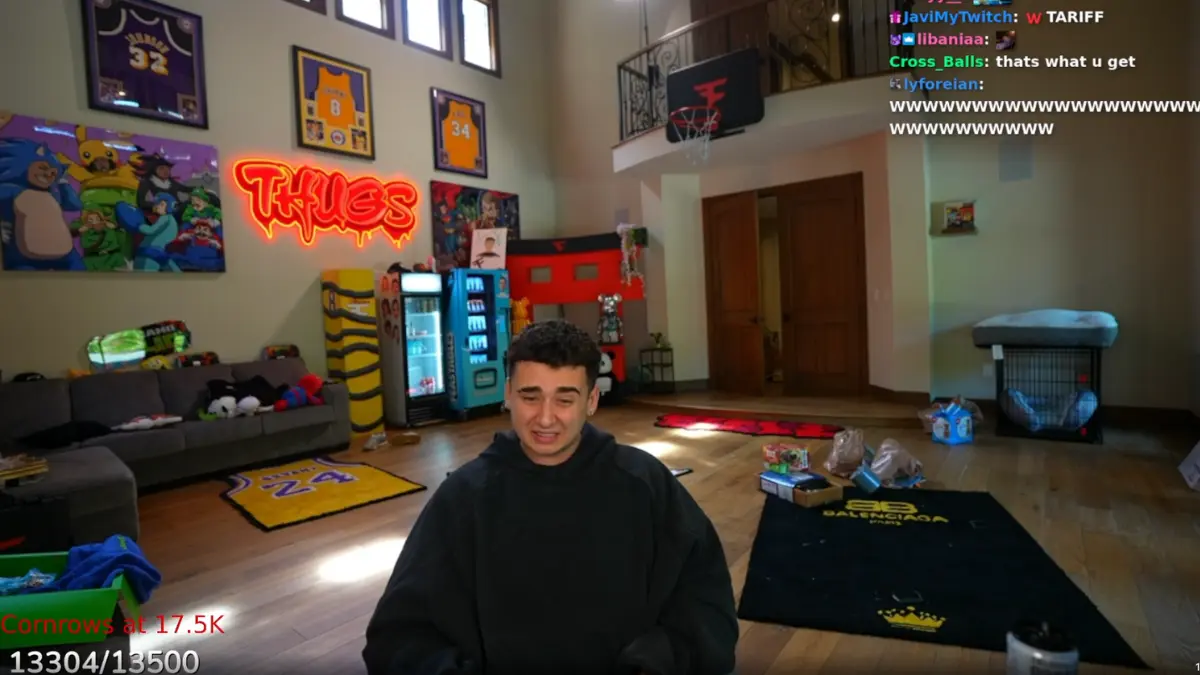 Person in gaming room with neon signs, jerseys.