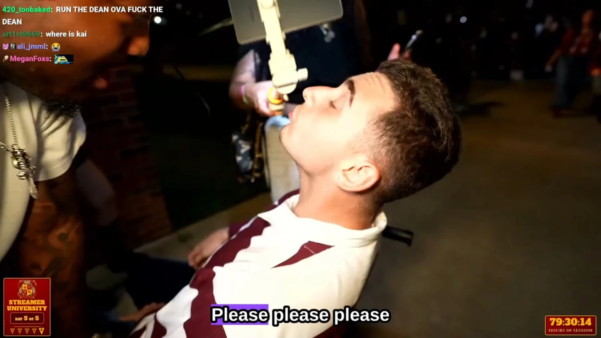 Man drinking from suspended bottle at event