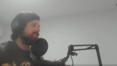 Man recording podcast with microphone and headphones