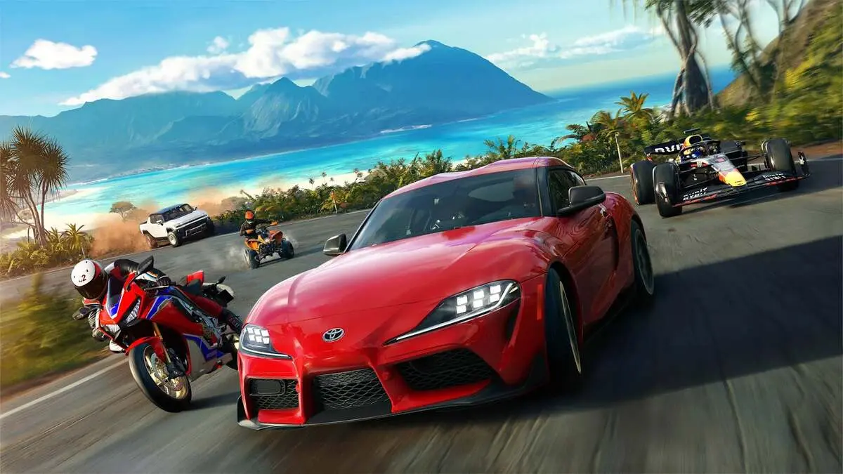 Red sports car racing along tropical coastal road