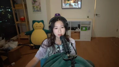 Woman streaming with microphone in cozy room