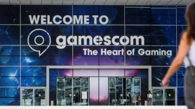 Gamescom entrance with welcome sign and visitors