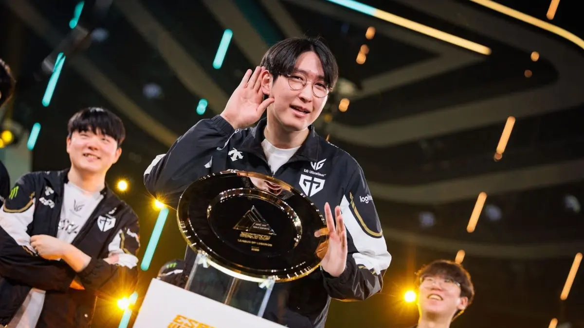 Esports team celebrating victory on stage with trophy.
