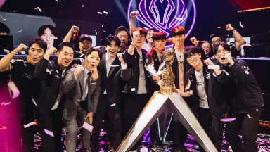 Esports team celebrating championship victory with trophy.