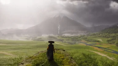 Person walking towards misty mountain landscape.