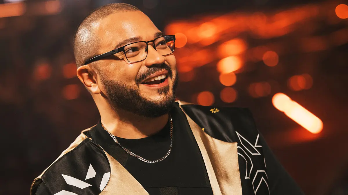 Smiling man with glasses in warm orange lighting