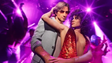 Couple dancing in a purple-lit nightclub