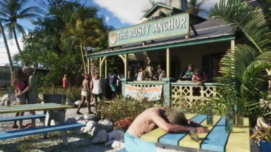 People gather outside The Rusty Anchor tropical bar