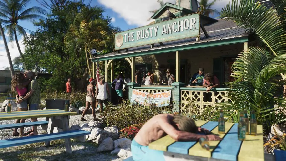 People gather outside The Rusty Anchor tropical bar