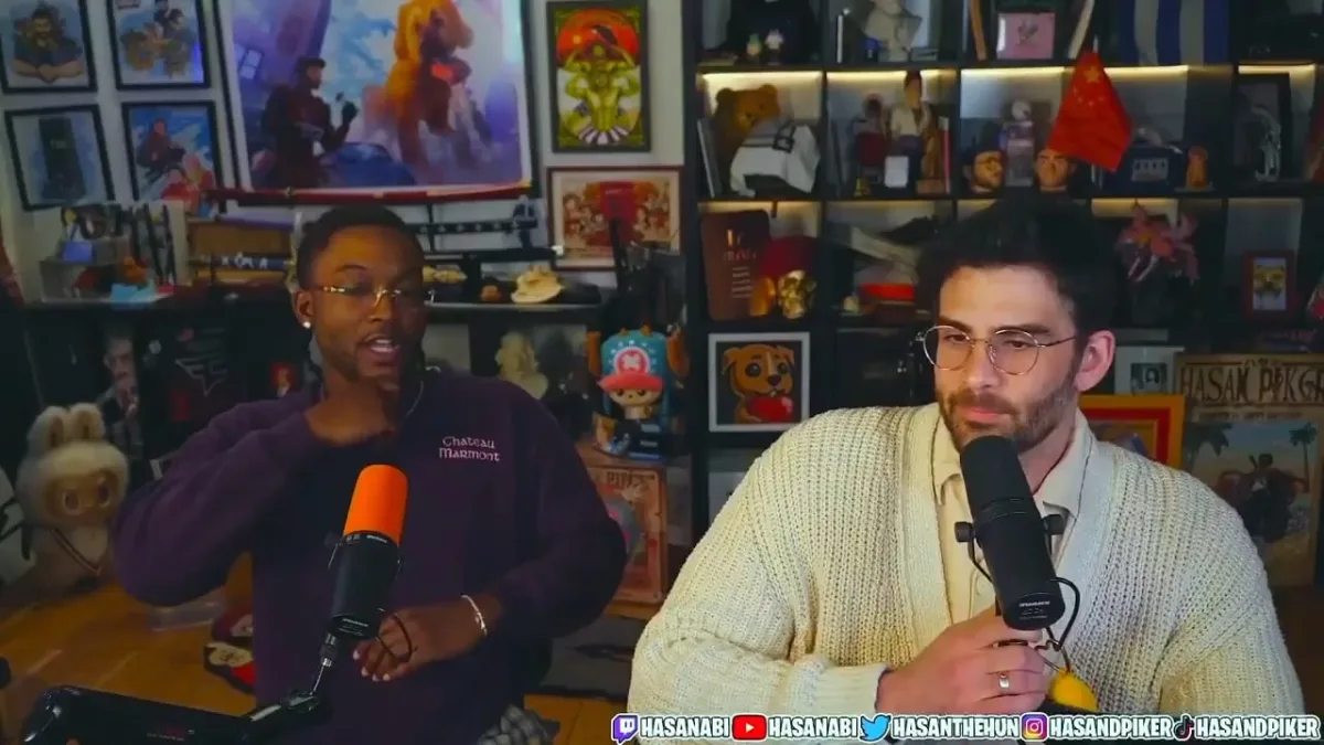 Two men speaking into microphones in studio