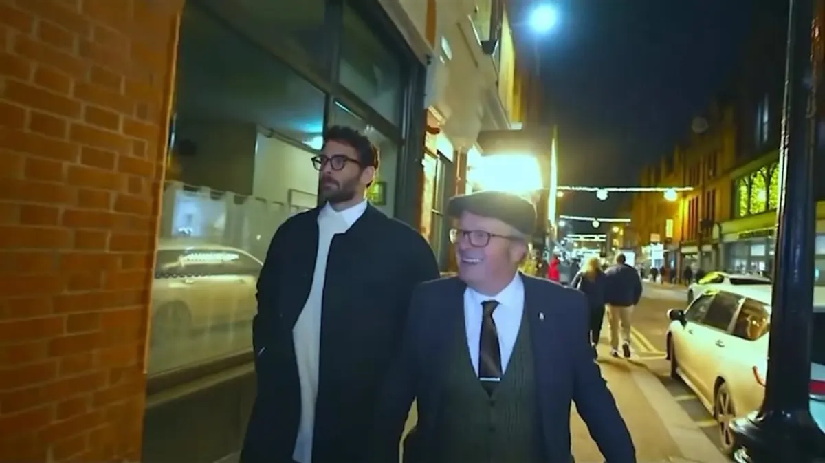 Two men walking on a city street at night