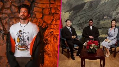 Man posing and meeting wax figures in museum