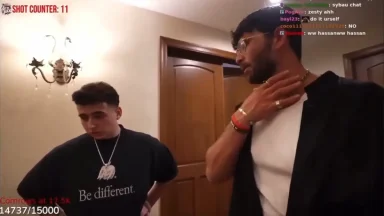 Two men talking in a warmly lit hallway