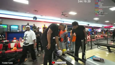 People bowling in a lively bowling alley.
