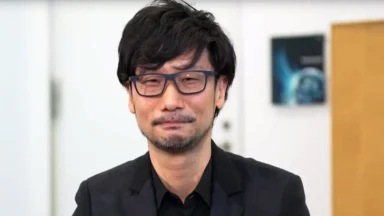 Man wearing glasses and black suit indoors