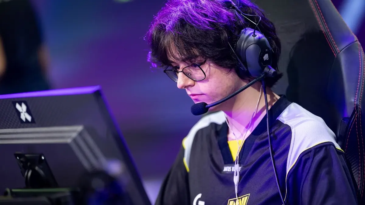 Esports player wearing headset focuses on computer monitor