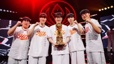 Esports team celebrating championship with trophy on stage