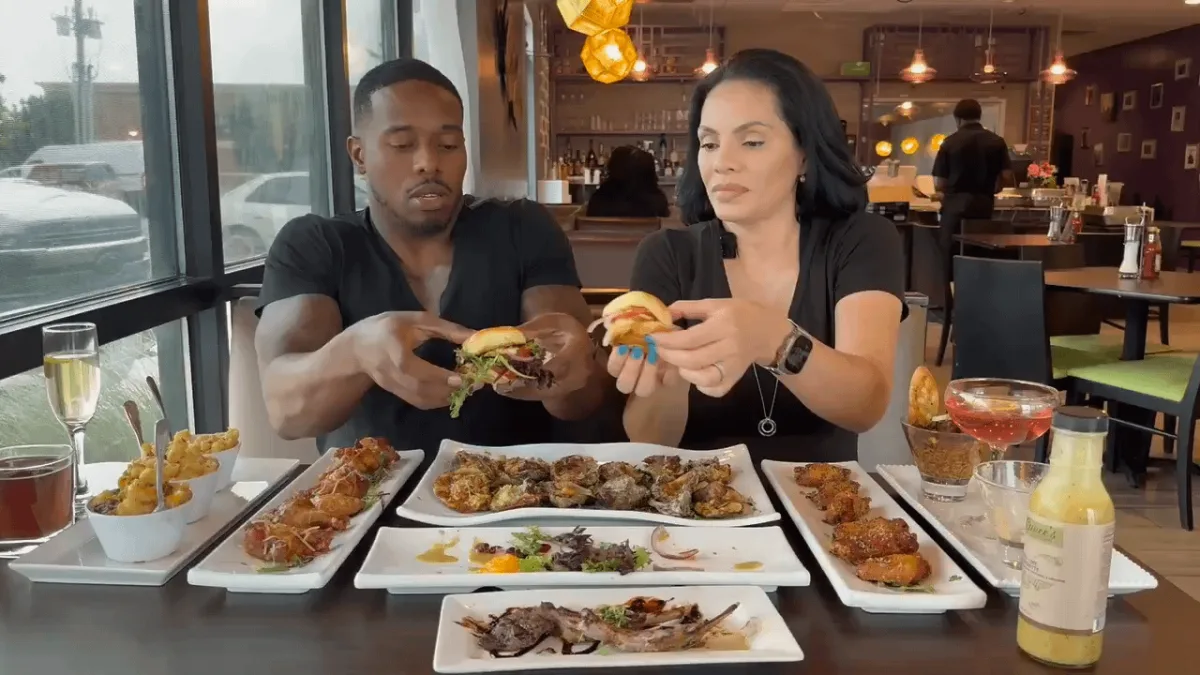 Couple enjoying diverse restaurant food selection.