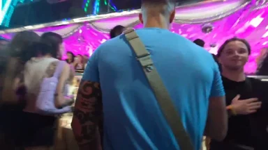 People socializing at colorful nightclub event