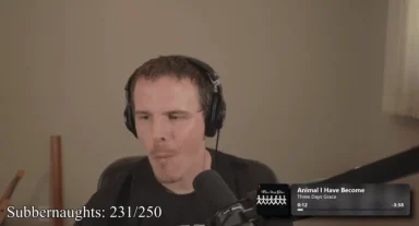 Person streaming with headphones and microphone.