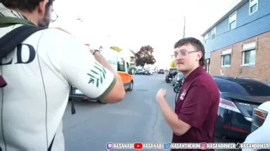 Two people talking on a street.