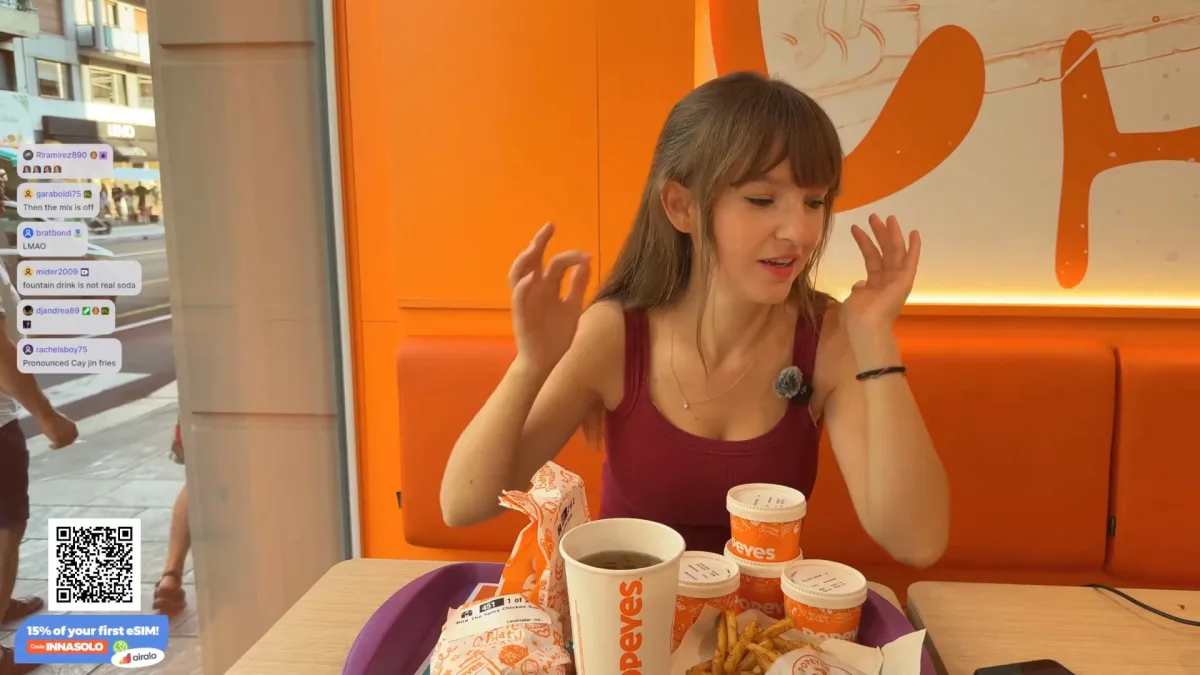 Woman eating Popeyes meal during livestream