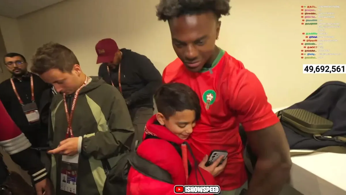 Man hugging child in Moroccan soccer jersey