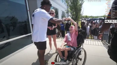 Person in wheelchair enjoying outdoor interaction.