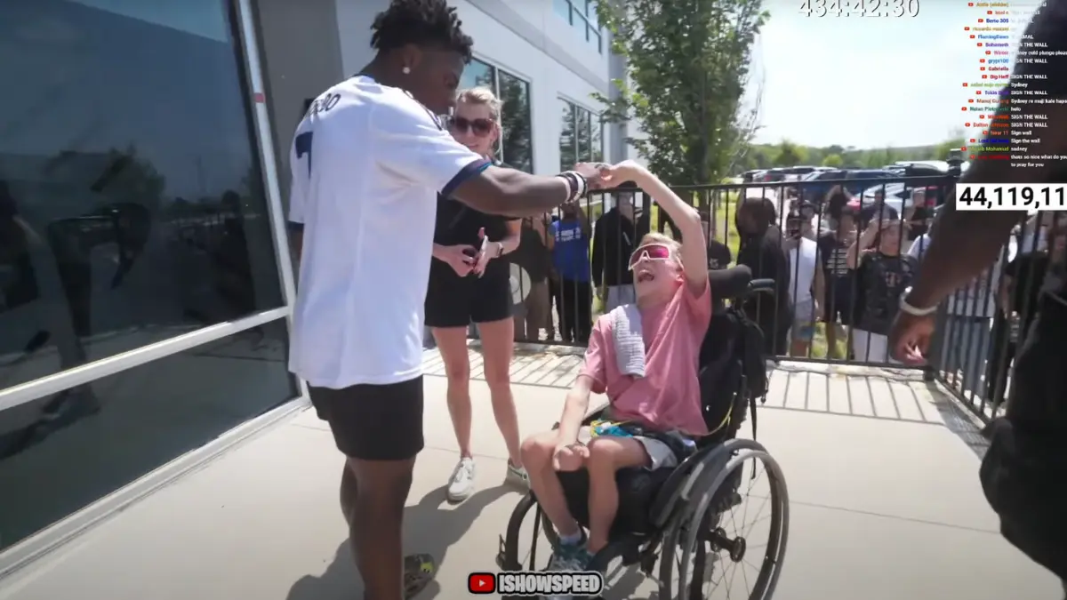 Person in wheelchair enjoying outdoor interaction.