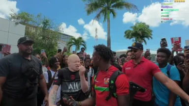 Crowd gathering around two men outdoors