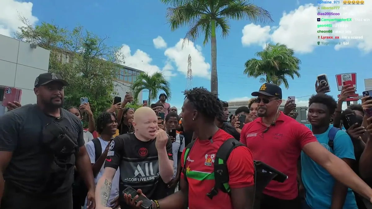 Crowd gathering around two men outdoors