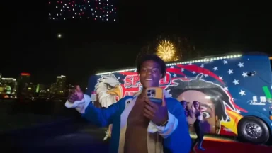 Person celebrating with fireworks and decorated bus