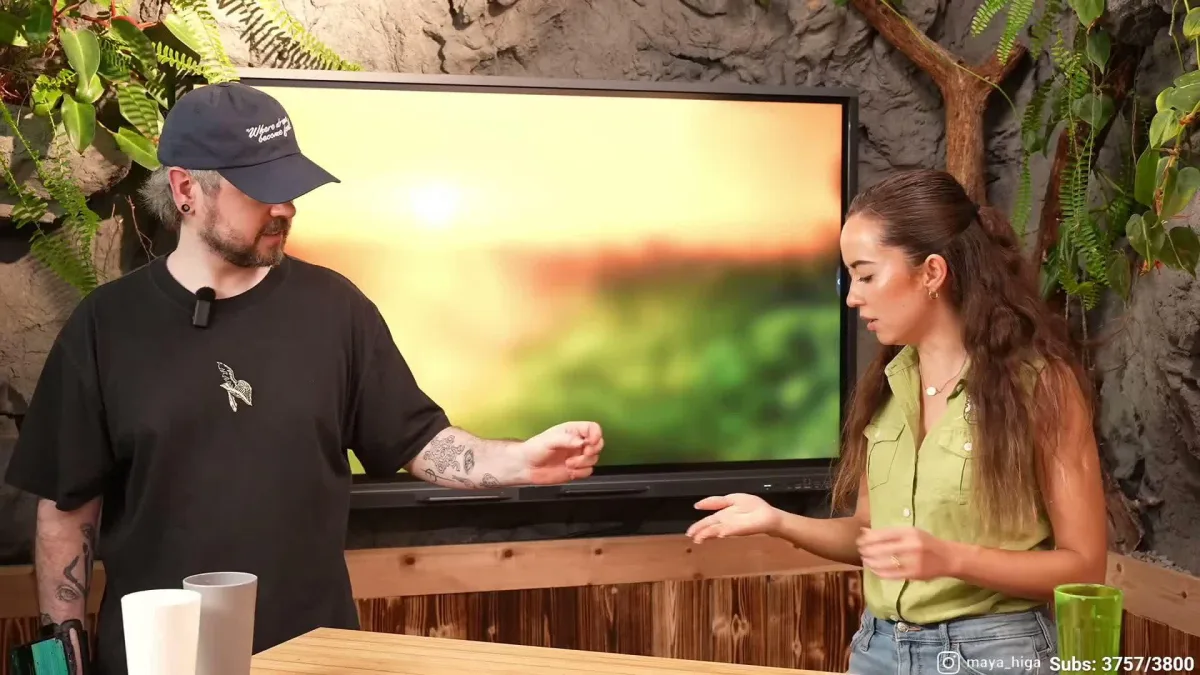 Man handing small object to woman indoors