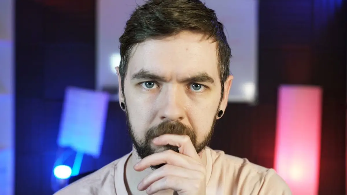 Bearded man with hand on chin, colorful lights