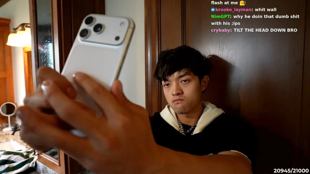 Young man taking selfie during livestream indoors