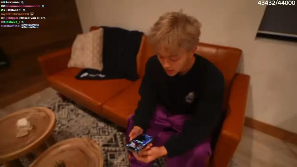 Person sitting on couch using smartphone