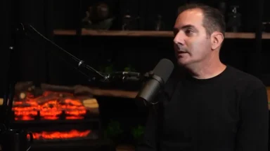 Man speaking into microphone in podcast studio