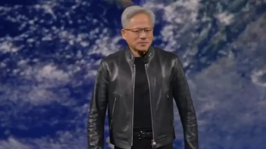Man in leather jacket on stage with Earth backdrop