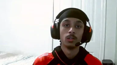 Young man wearing headset and durag indoors
