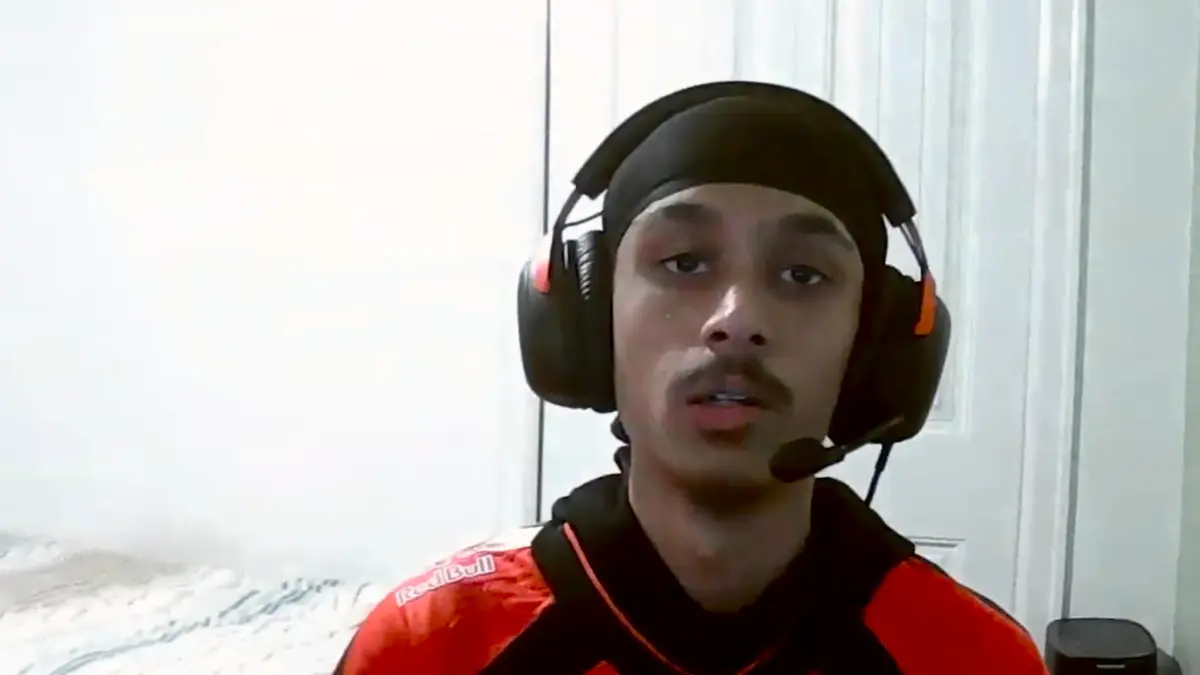 Young man wearing headset and durag indoors