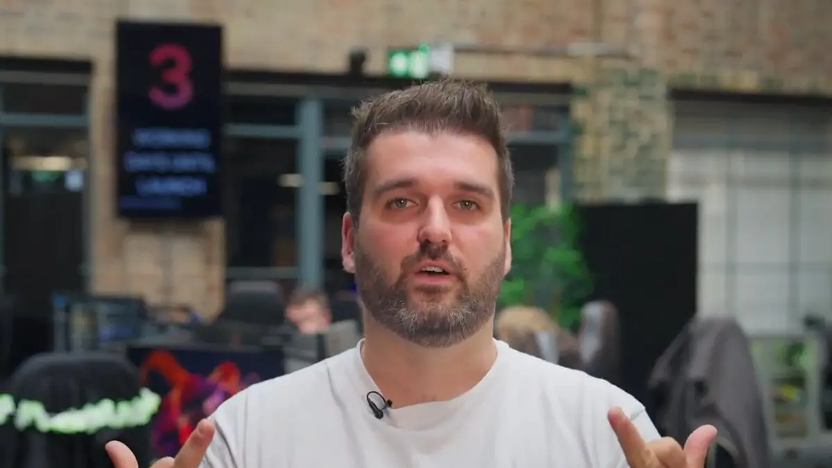 Man speaking in modern office with raised hands