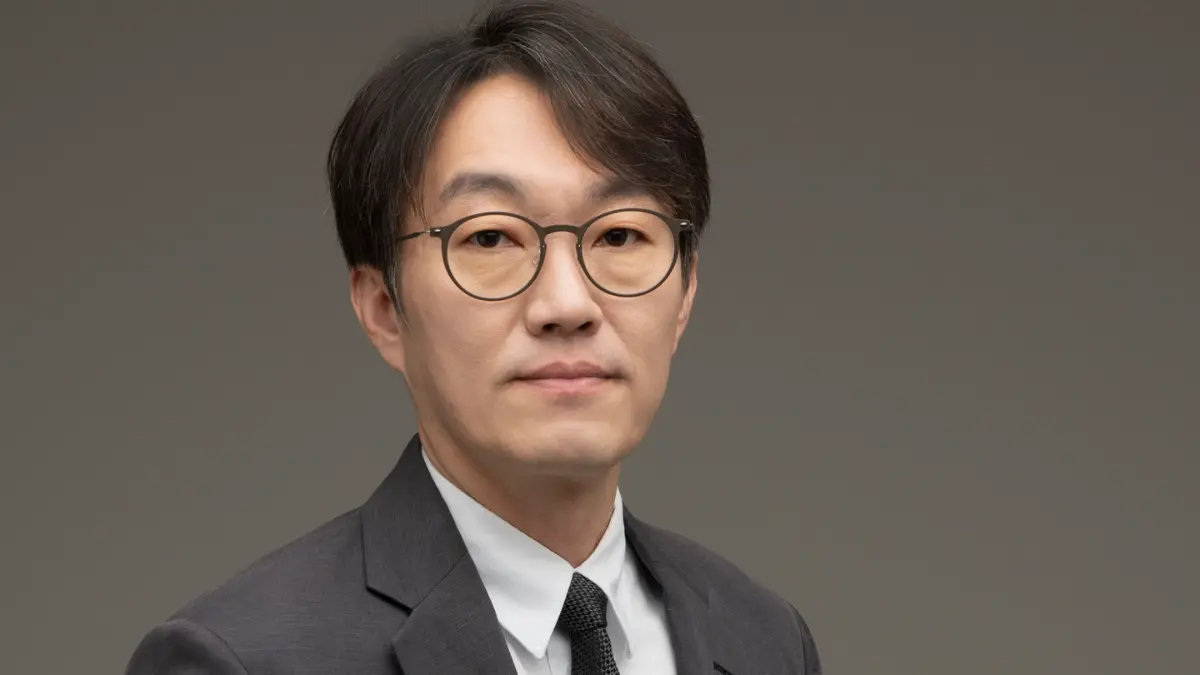 Man wearing glasses and a formal suit