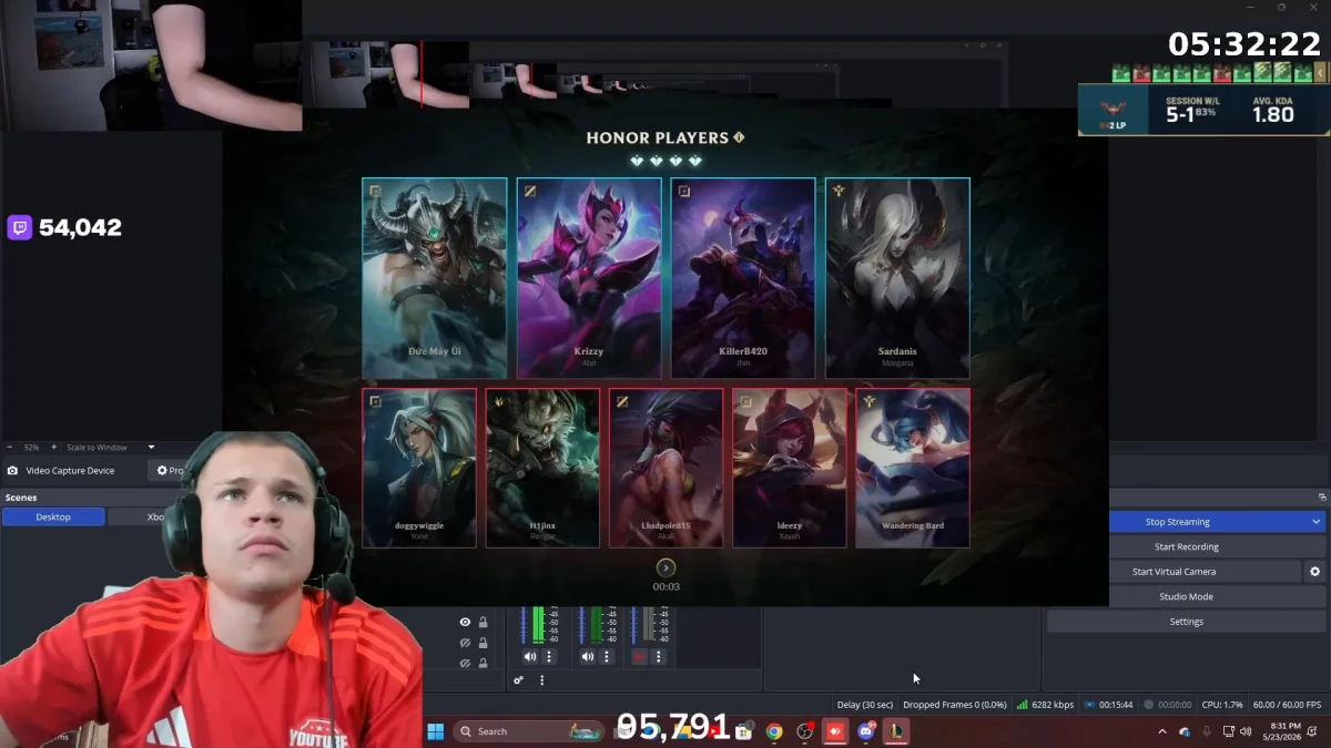 Gamer streaming fantasy game on computer setup