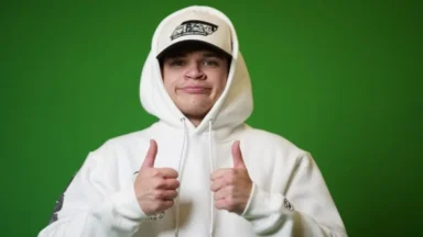 Man in white hoodie giving thumbs up