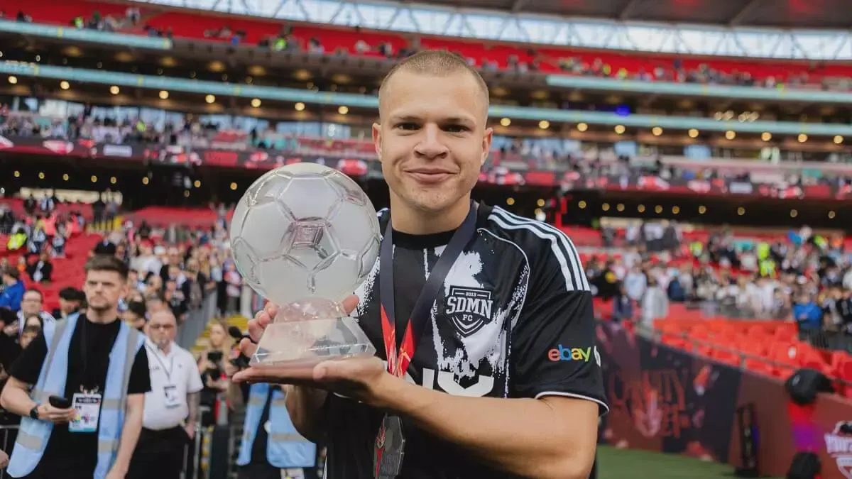 Man holding soccer trophy in stadium