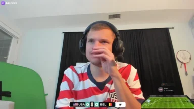 Man in USA jersey watching soccer match livestream